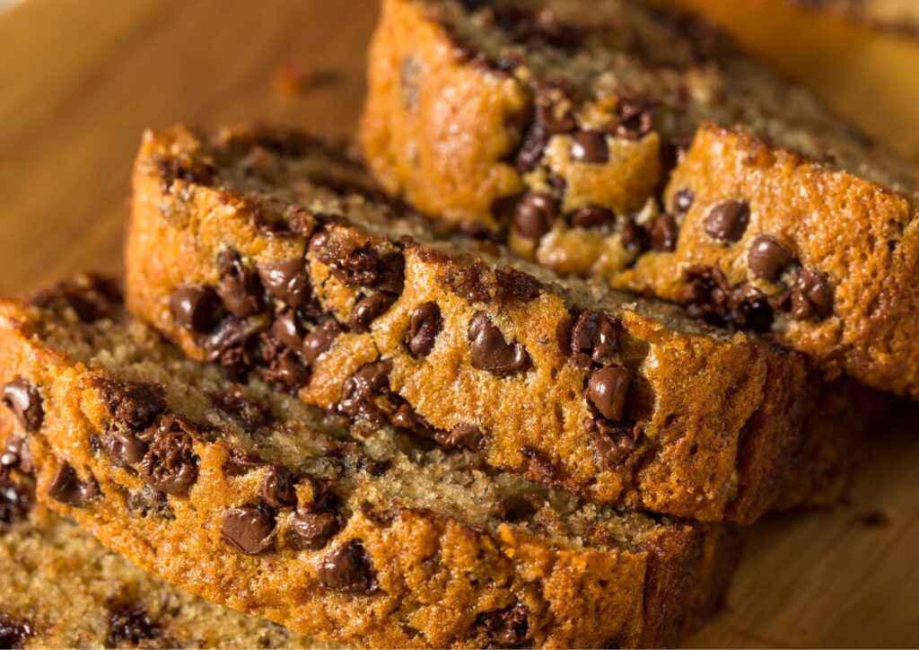 slices of chocolate chip banana bread sitting on cutting board