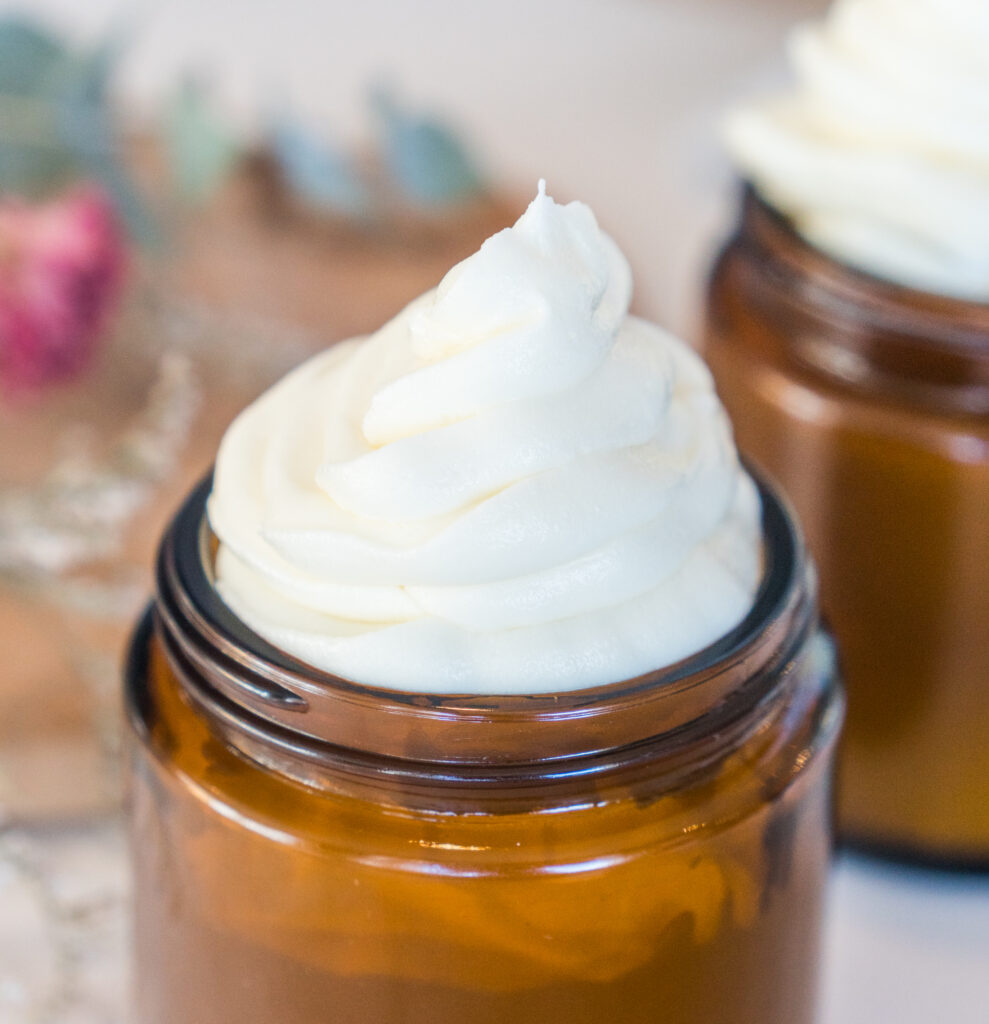 whipped tallow face cream in an amber jar